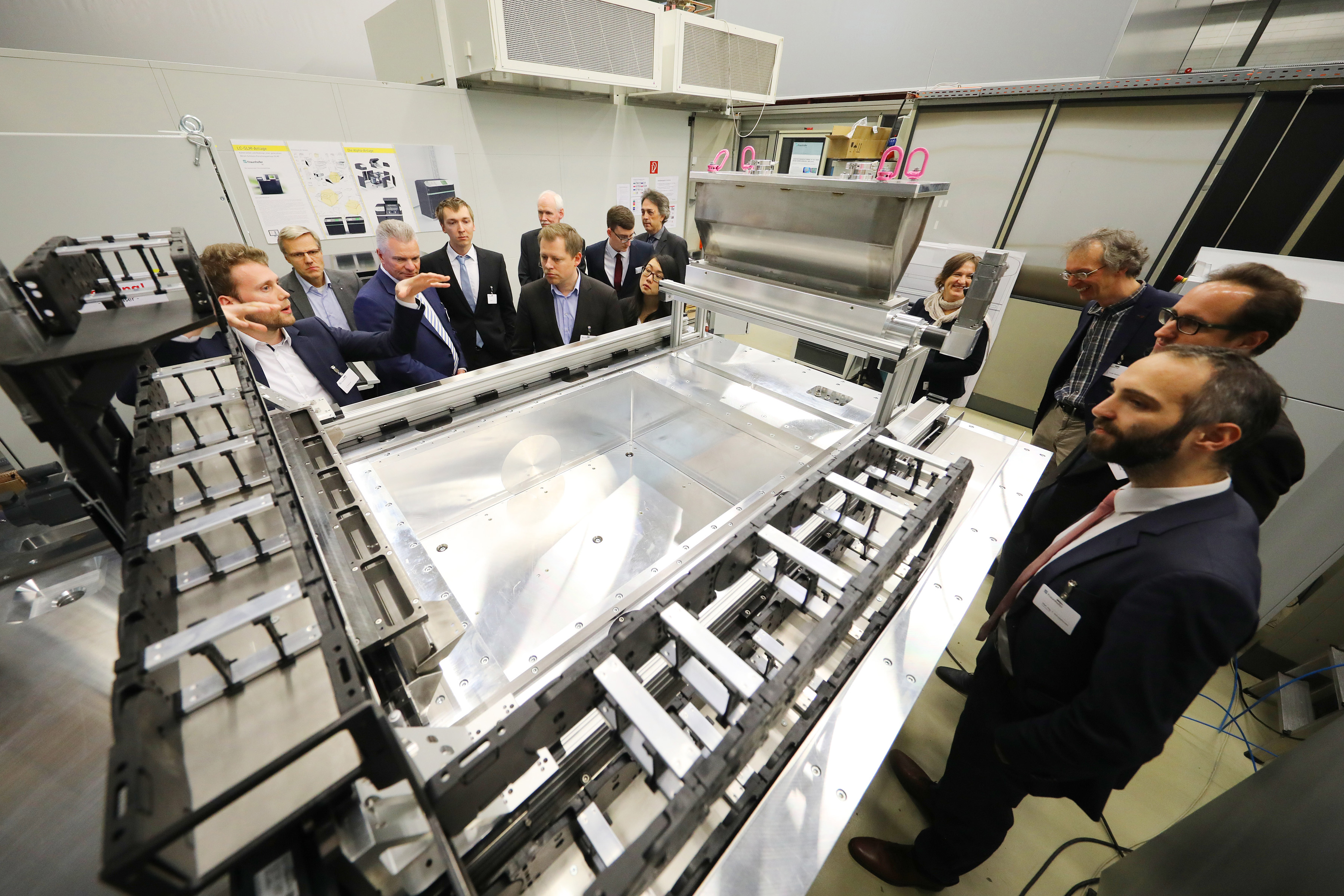 Christian Tenbrock, of Fraunhofer ILT, presents the SLM laboratory equipment for large metal components to the participants of the futureAM kick-off meeting. Christian Tenbrock, of Fraunhofer ILT, presents the SLM laboratory equipment for large metal components to the participants of the futureAM kick-off meeting.