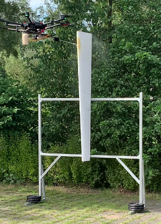Coating drone dur-ing a spray test: The coating material is applied by the drone via a lance Coating drone during a spray test: The coating material is applied by the drone via a lance