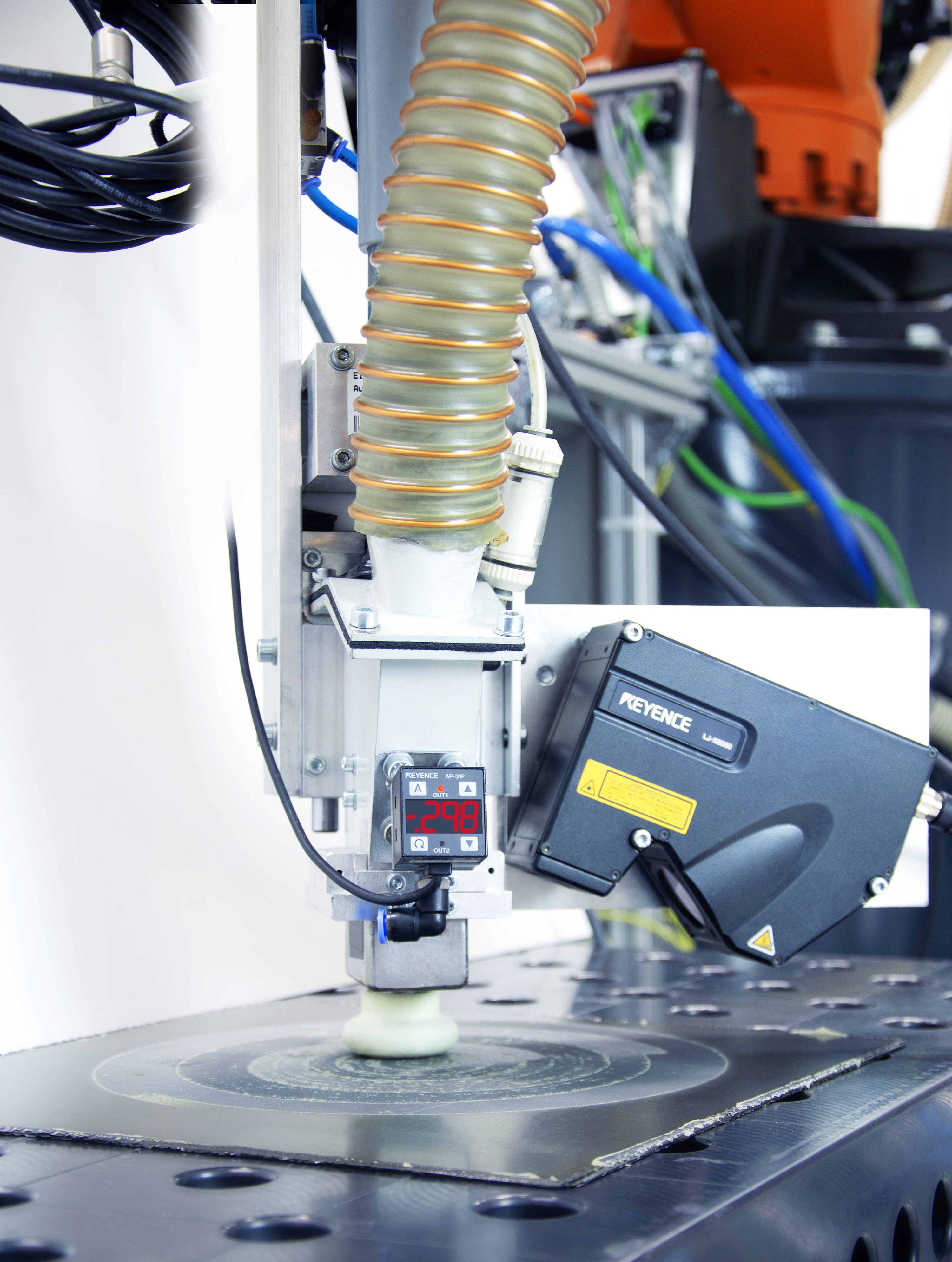 In addition to the robotic end effector including vacuum suction blasting nozzle, the newly developed vacuum suction blasting system includes a removal control sensor for inline monitoring for quality assurance. In addition to the robotic end effector including vacuum suction blasting nozzle, the newly developed vacuum suction blasting system includes a removal control sensor for inline monitoring for quality assurance.